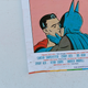A poster portraying Batman kissing Superman